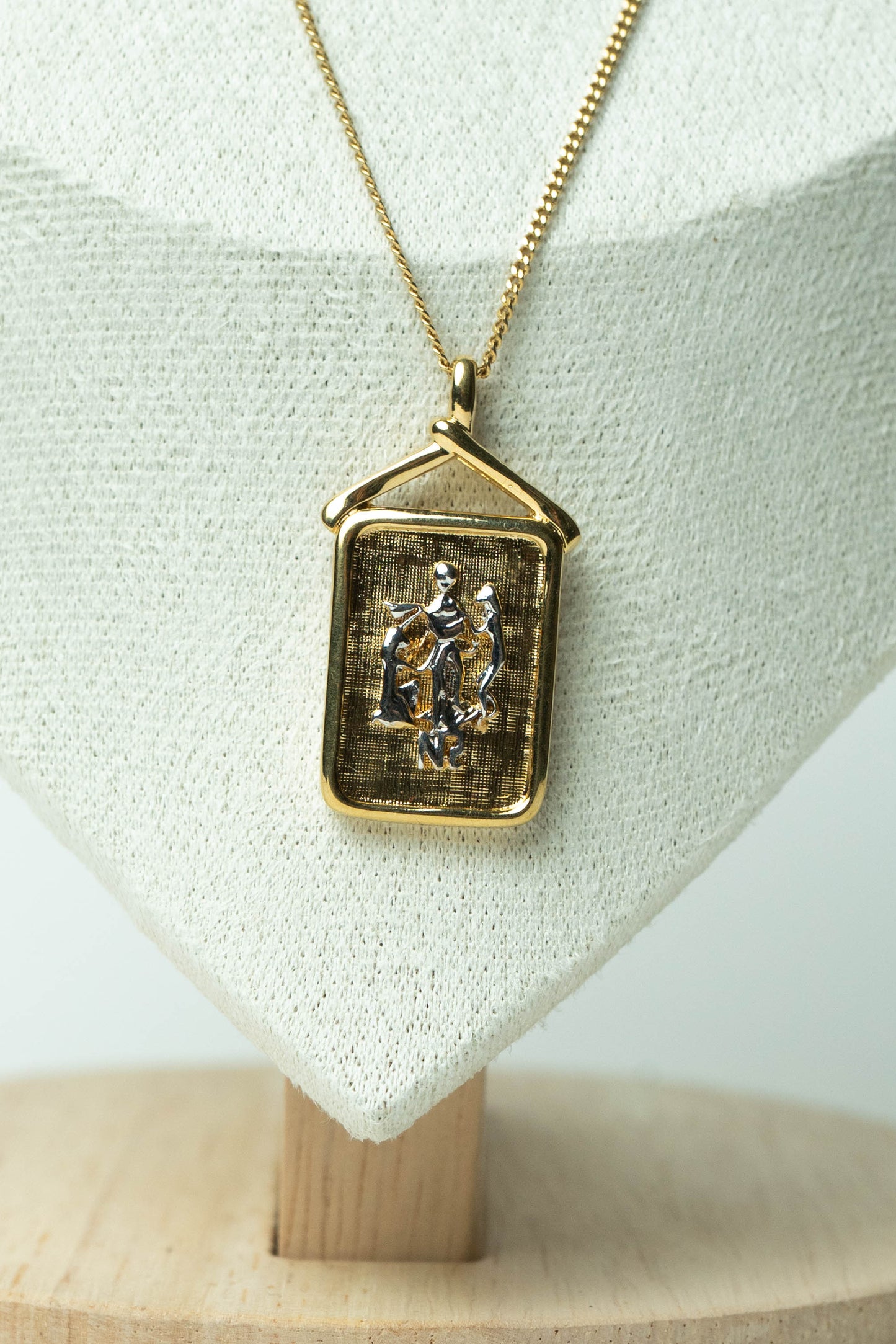 The Nina Ricci Bas-Relief Crest Pendant Necklace